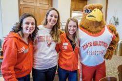 Students pose with Rocky at homecoming